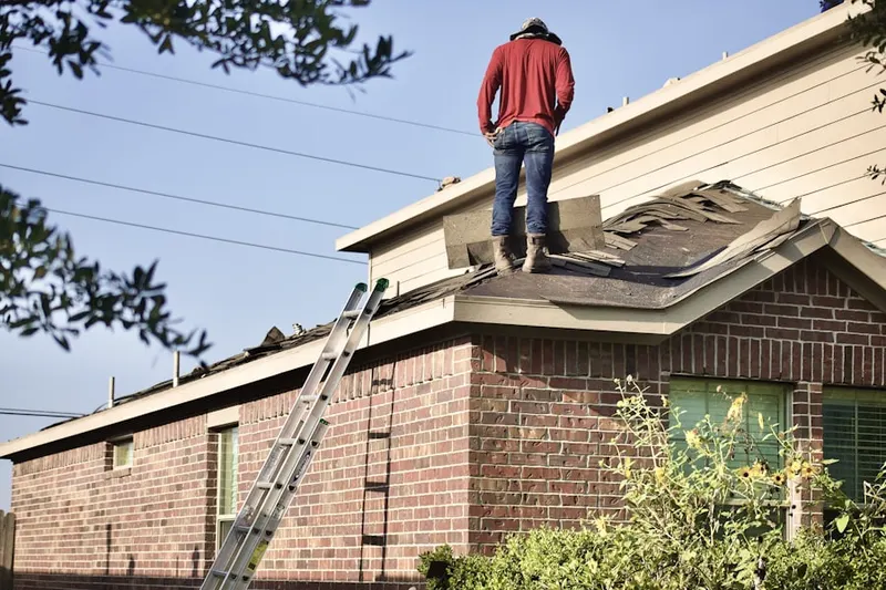 Professional roofer working on a residential roof in College Hills